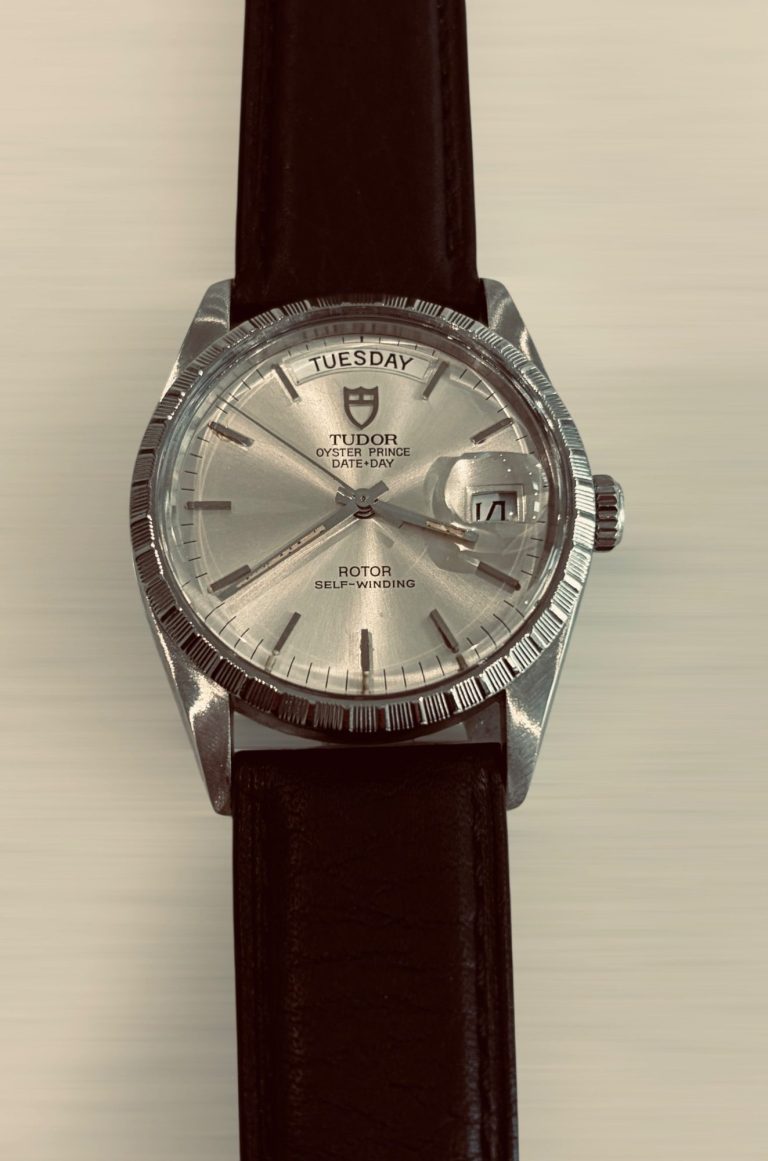 Vintage Tudor watch with a silver dial and brown leather strap